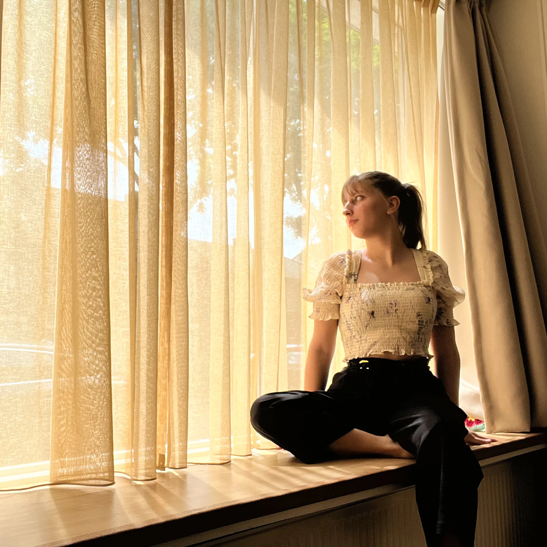 Bruna, looking longingly through a window